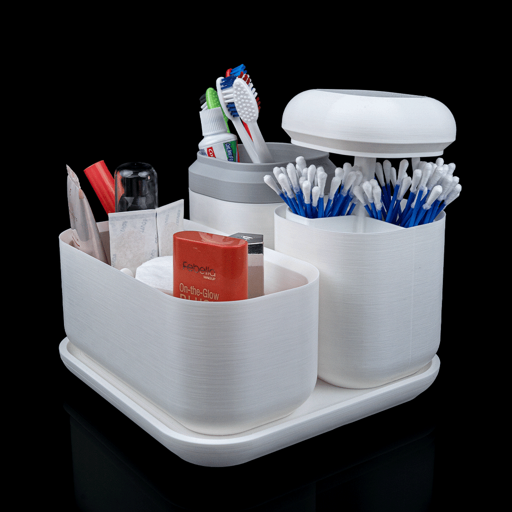 White bathroom caddy with toothbrushes, toothpaste, and other toiletries on a black background