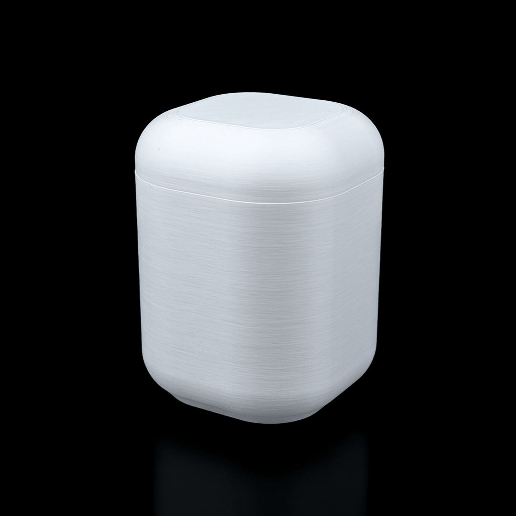 White cylindrical container with lid on a black background