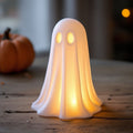 Cute little Halloween ghost tealight holder glowing with LED light
