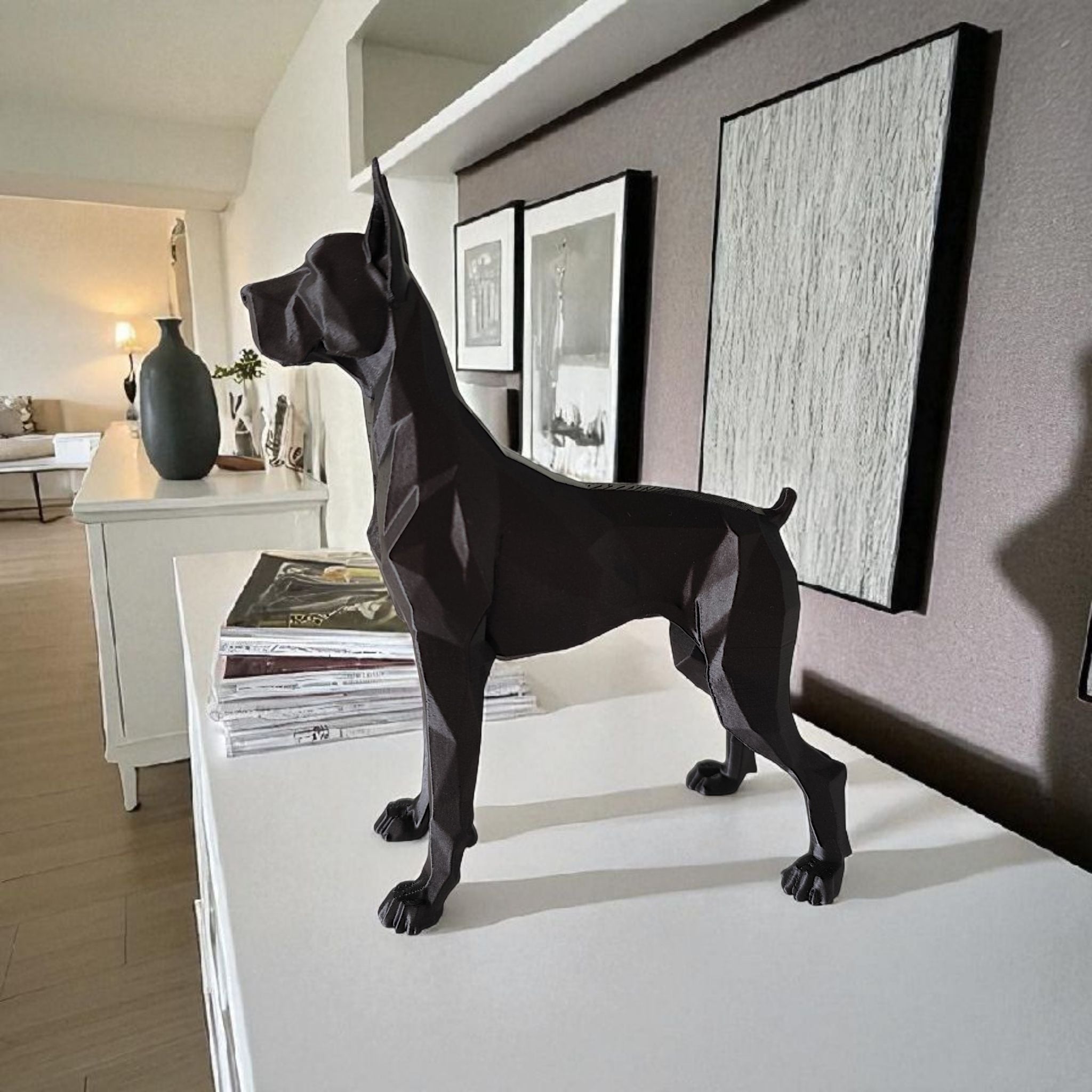 Black geometric dog sculpture on a white surface in a modern living room.