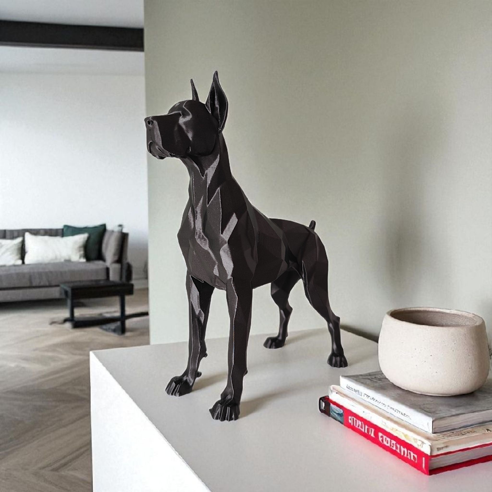 Black dog statue on a table with books and a plant pot in a living room setting