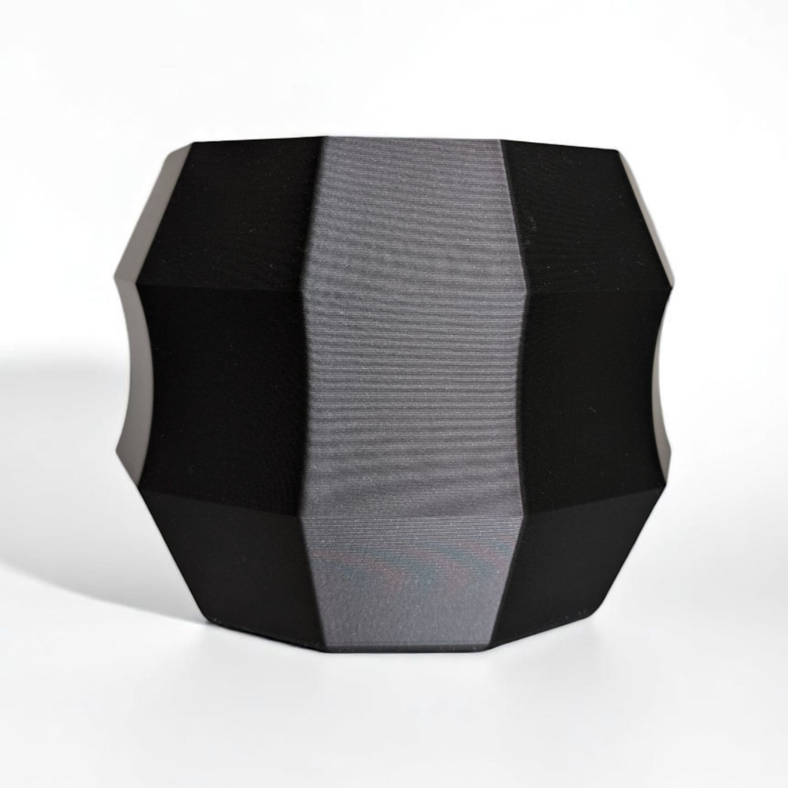 Geometric black and gray speaker on a white background