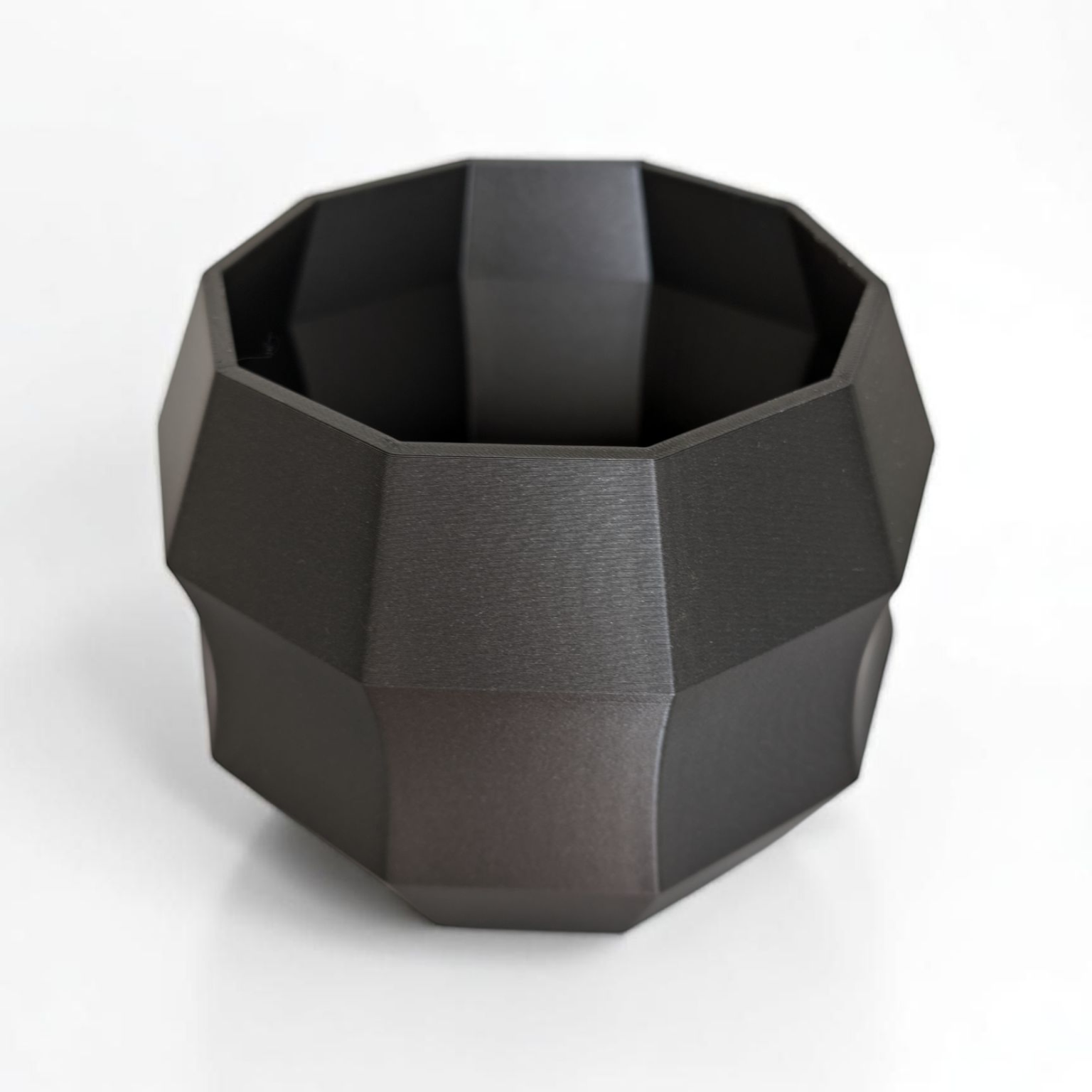 Black geometric vase on a white background