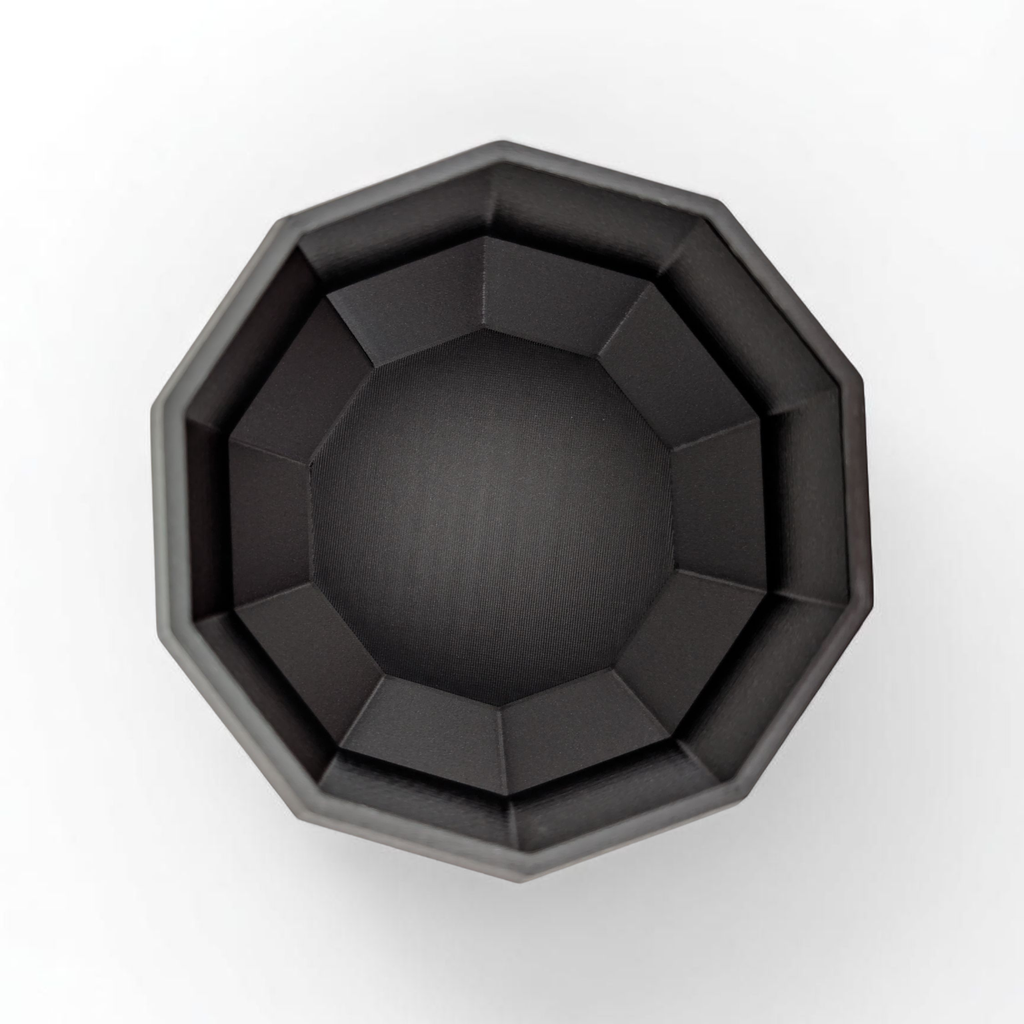 Black octagonal planter on a white background