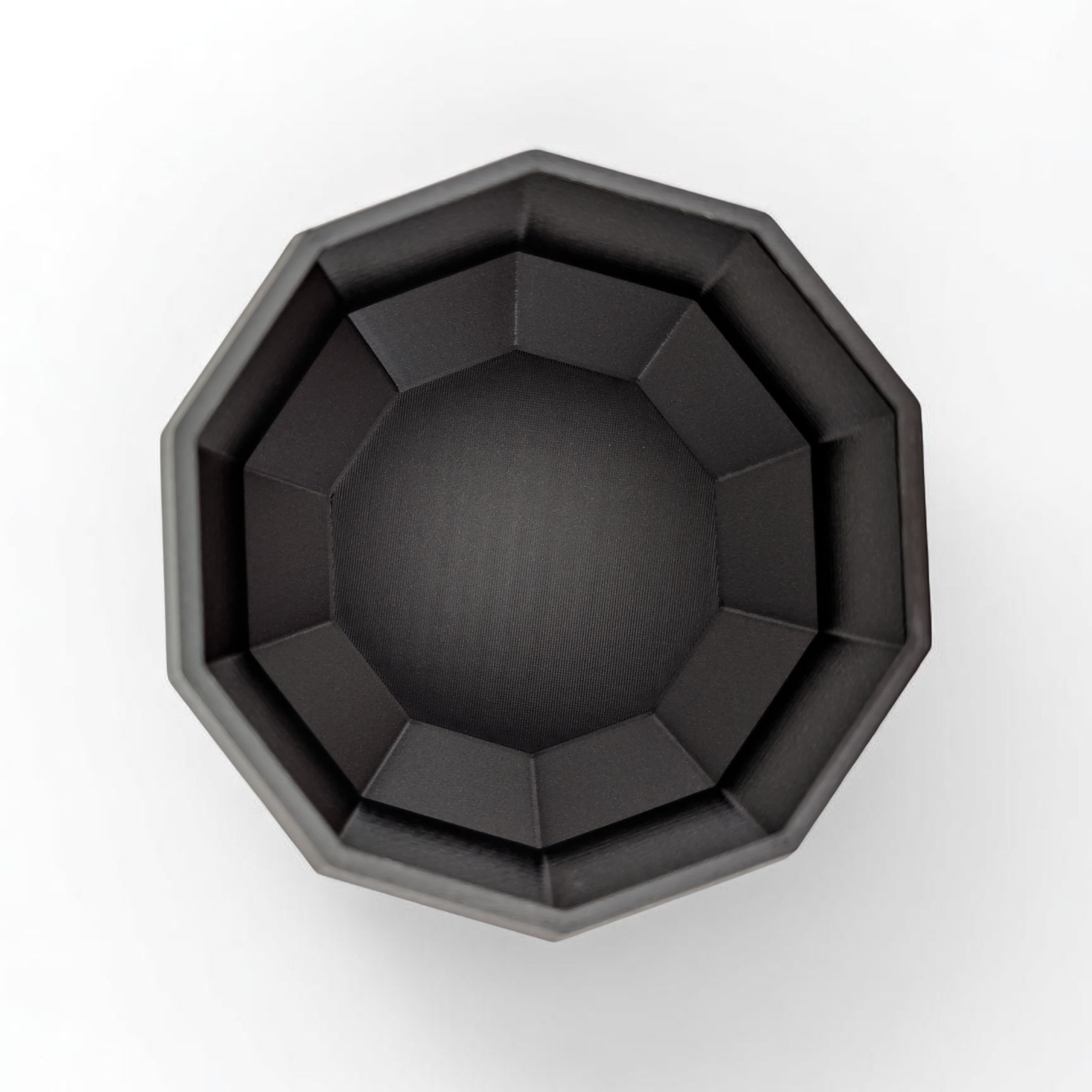 Black octagonal planter on a white background