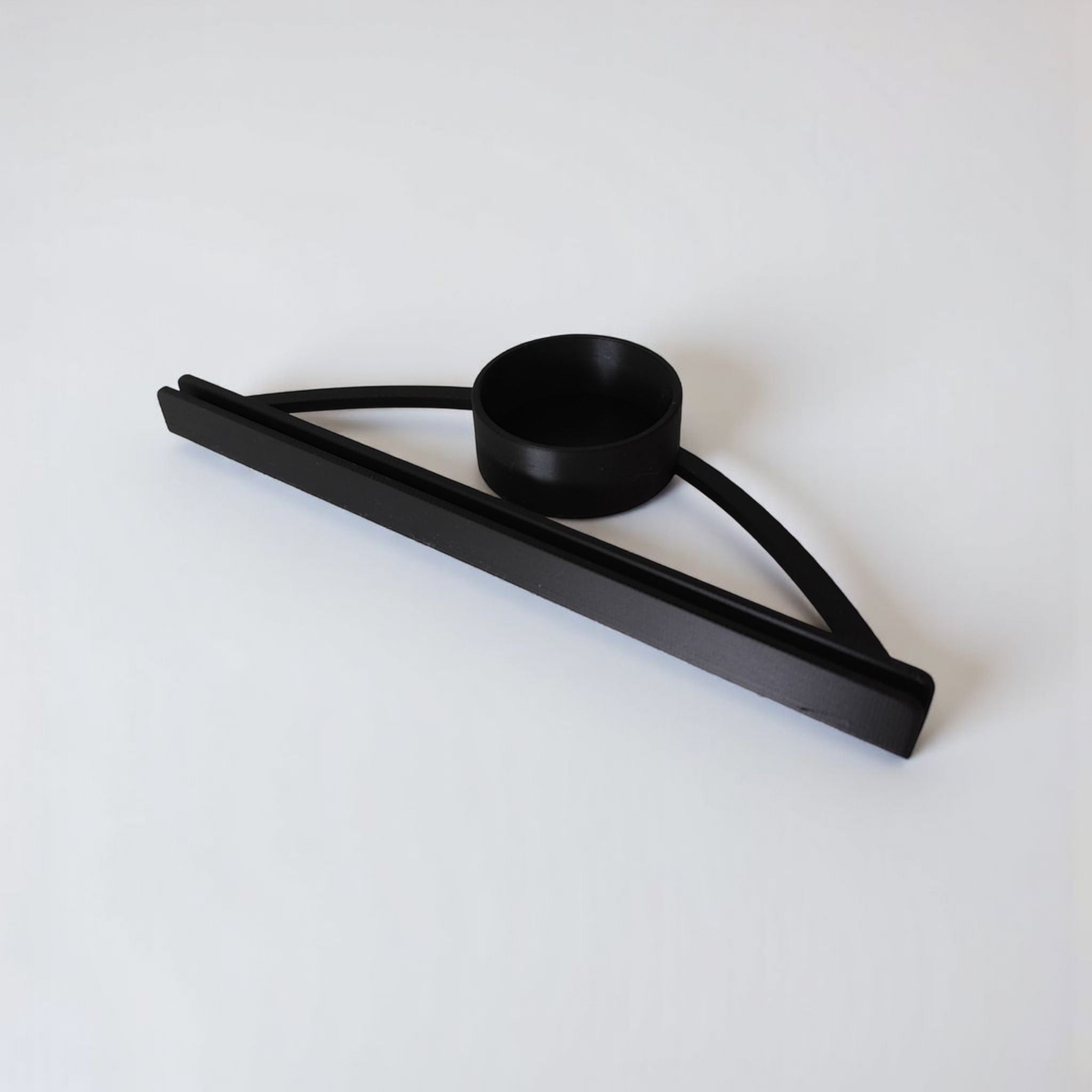 Black metal tray with two black metal bars on a white background