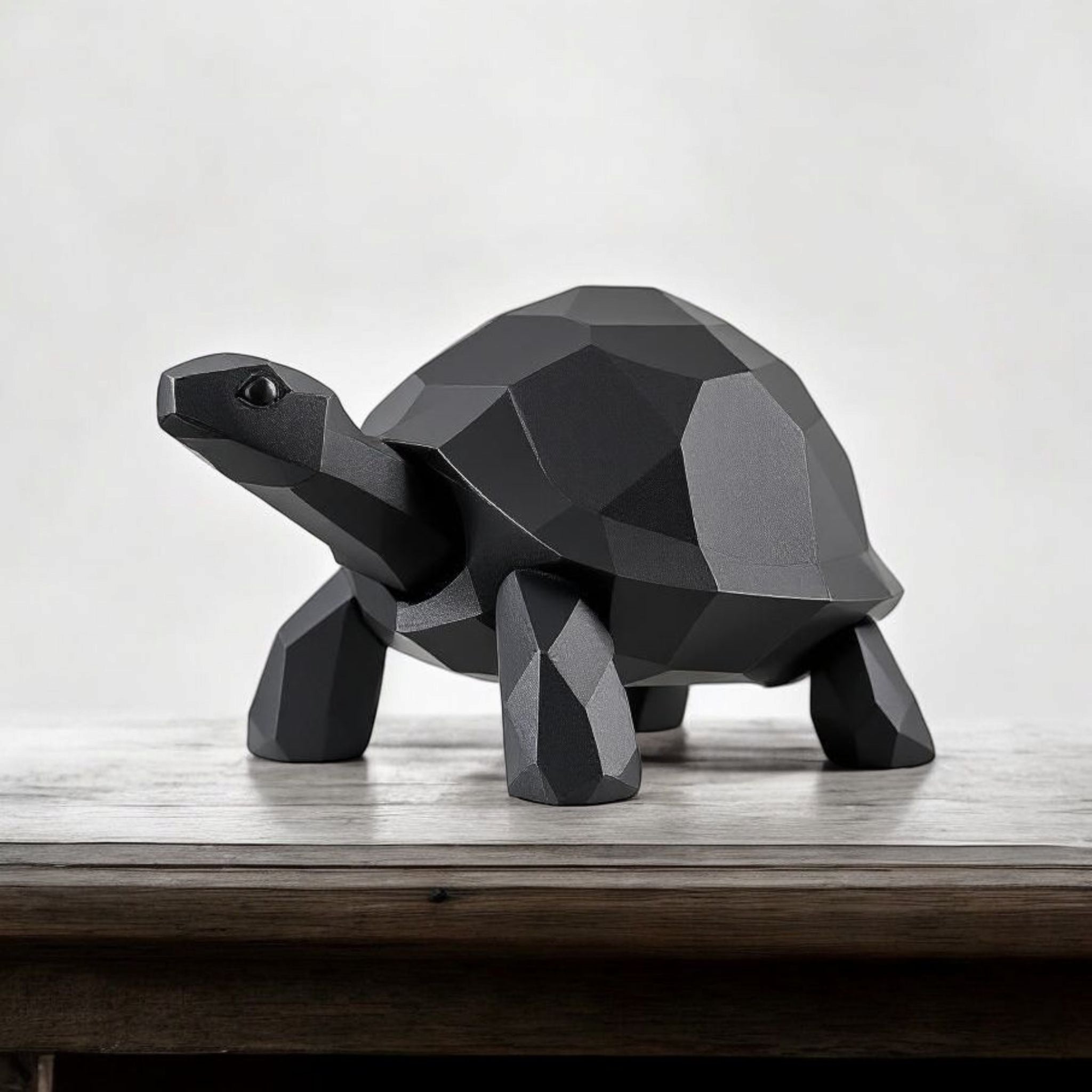 Geometric turtle sculpture on a wooden surface with a white background