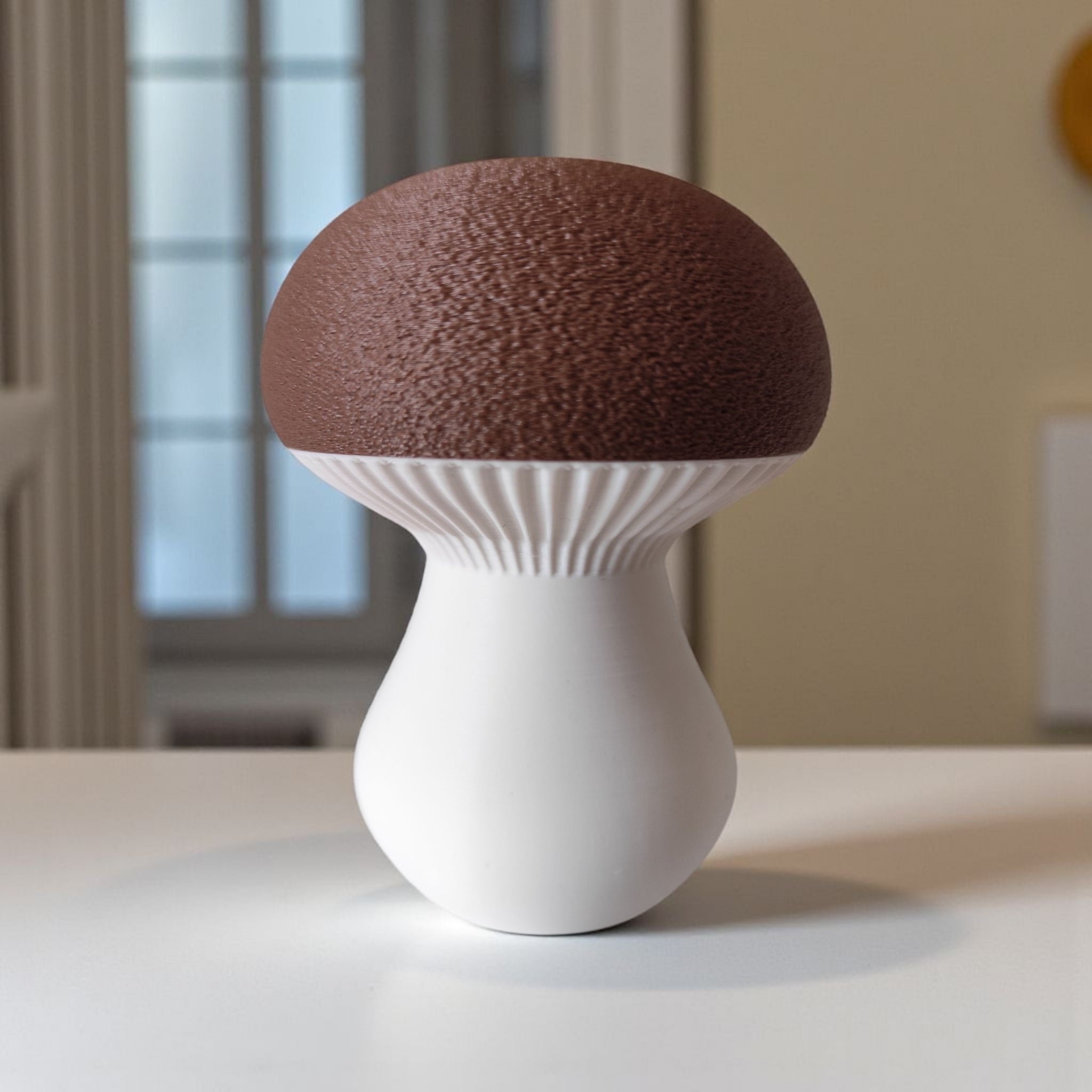 Mushroom-shaped decorative item with brown top and white base on a neutral background