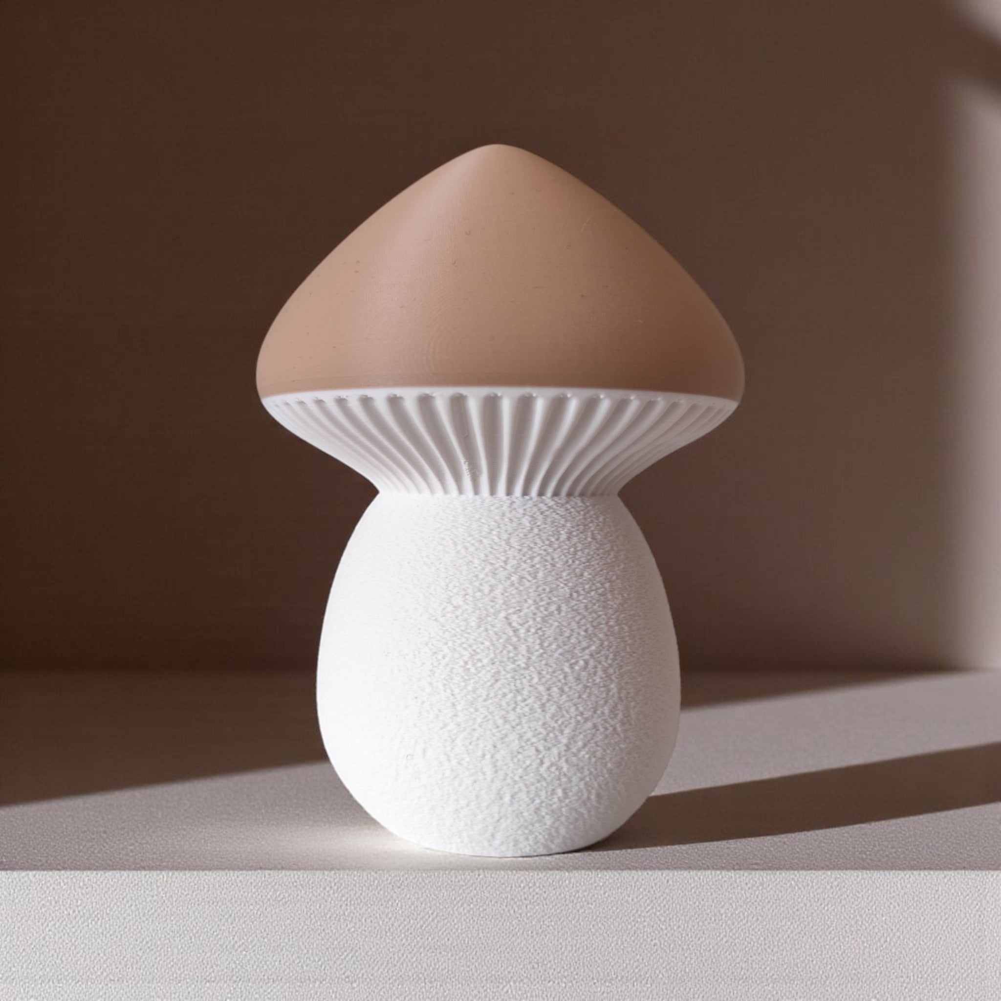 Mushroom-shaped lamp with brown cap and white base on a neutral background