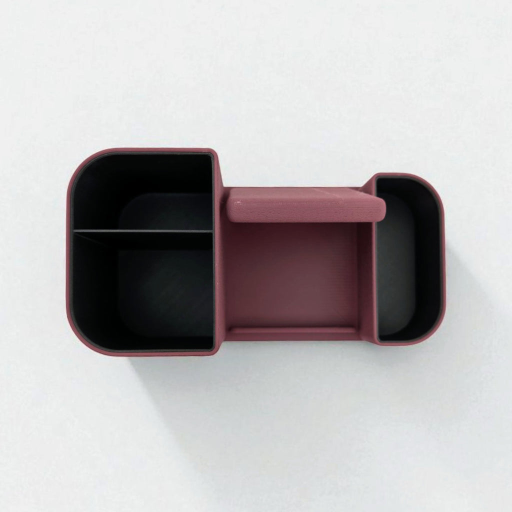 Maroon bento box with black interior compartments on a white background