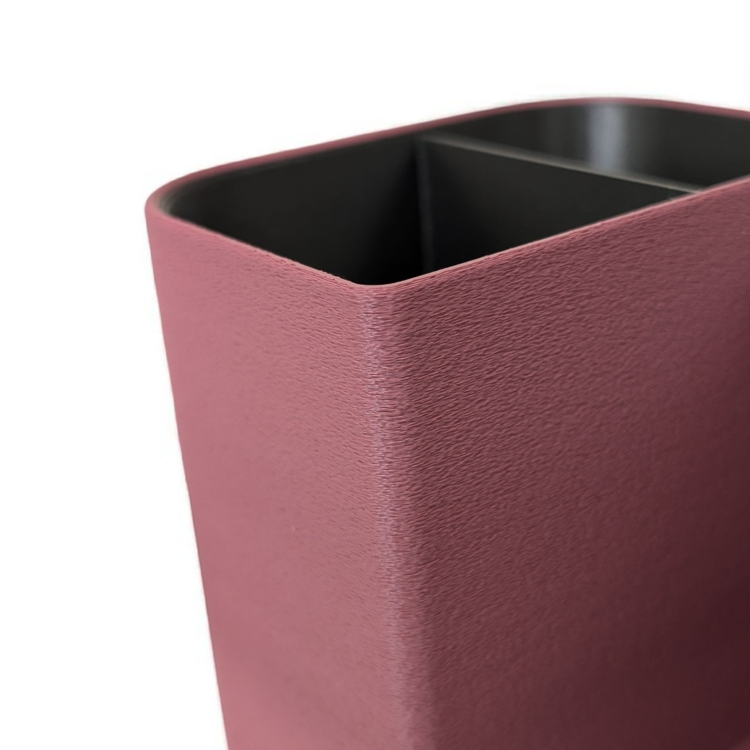 Close-up of a pink rectangular planter with a black interior on a white background