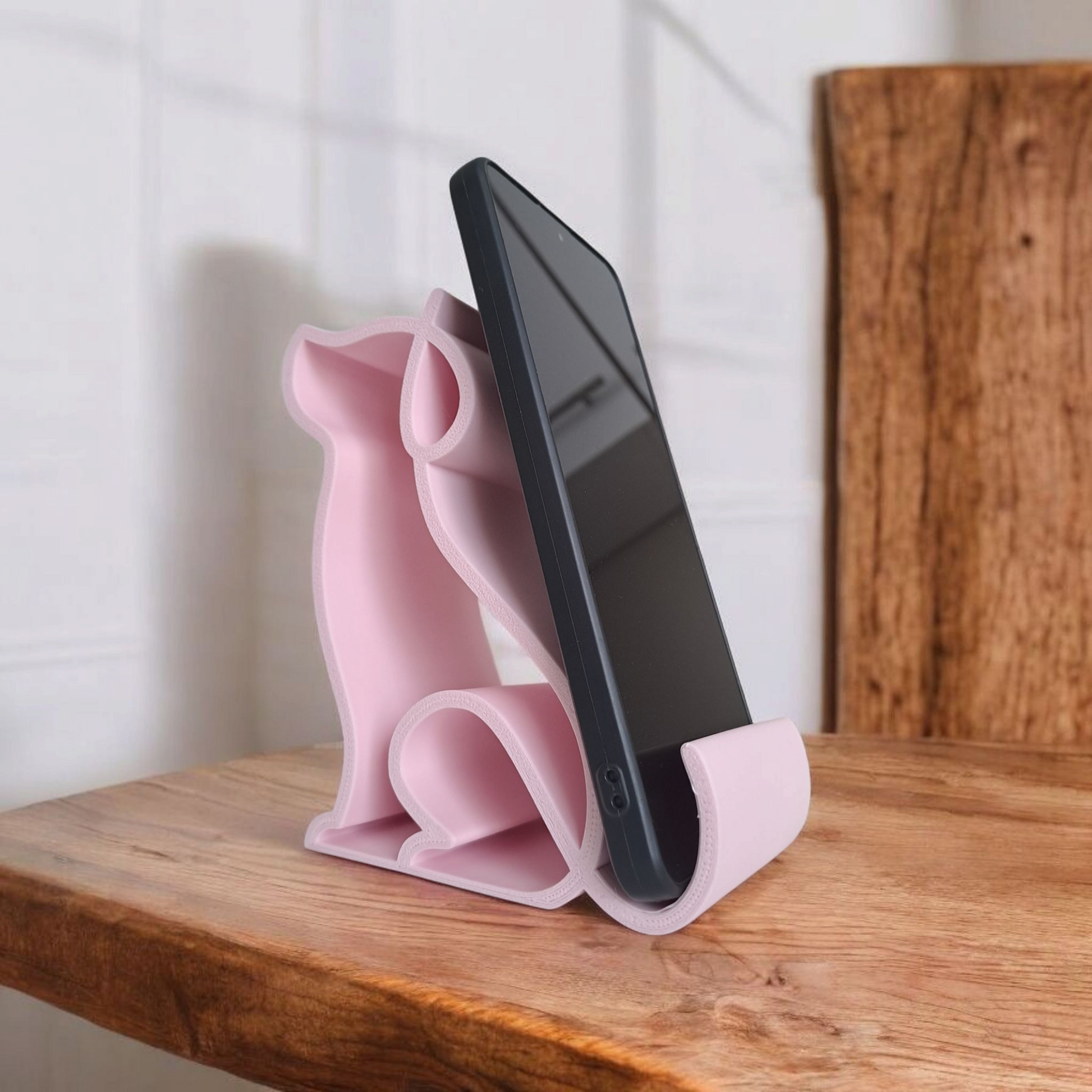 Cute Dog Phone Stand holding a smartphone on a desk