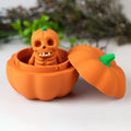 Pumpkin-shaped container with a skeleton toy inside, on a white background