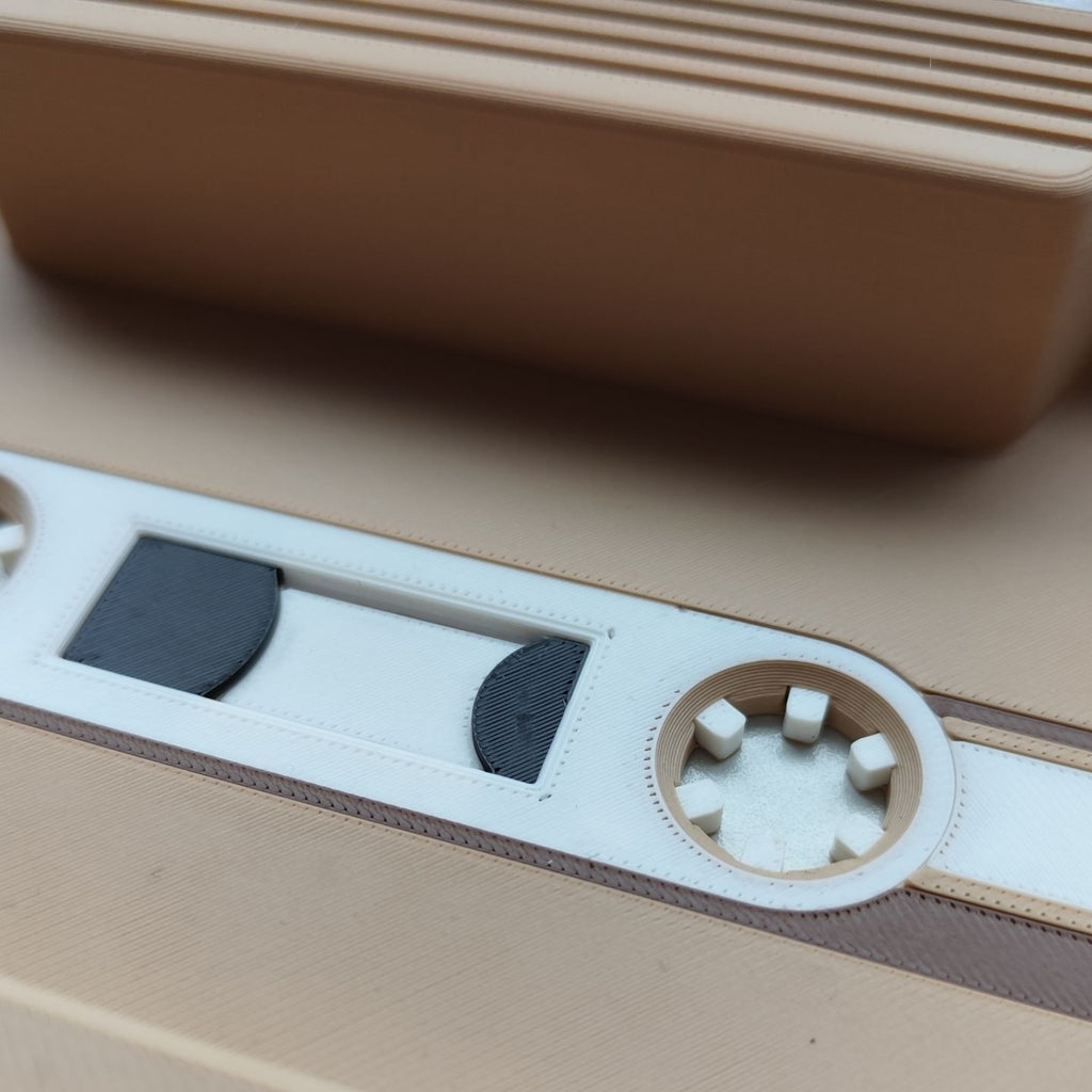 Close-up of a cassette tape with a brown player in the background