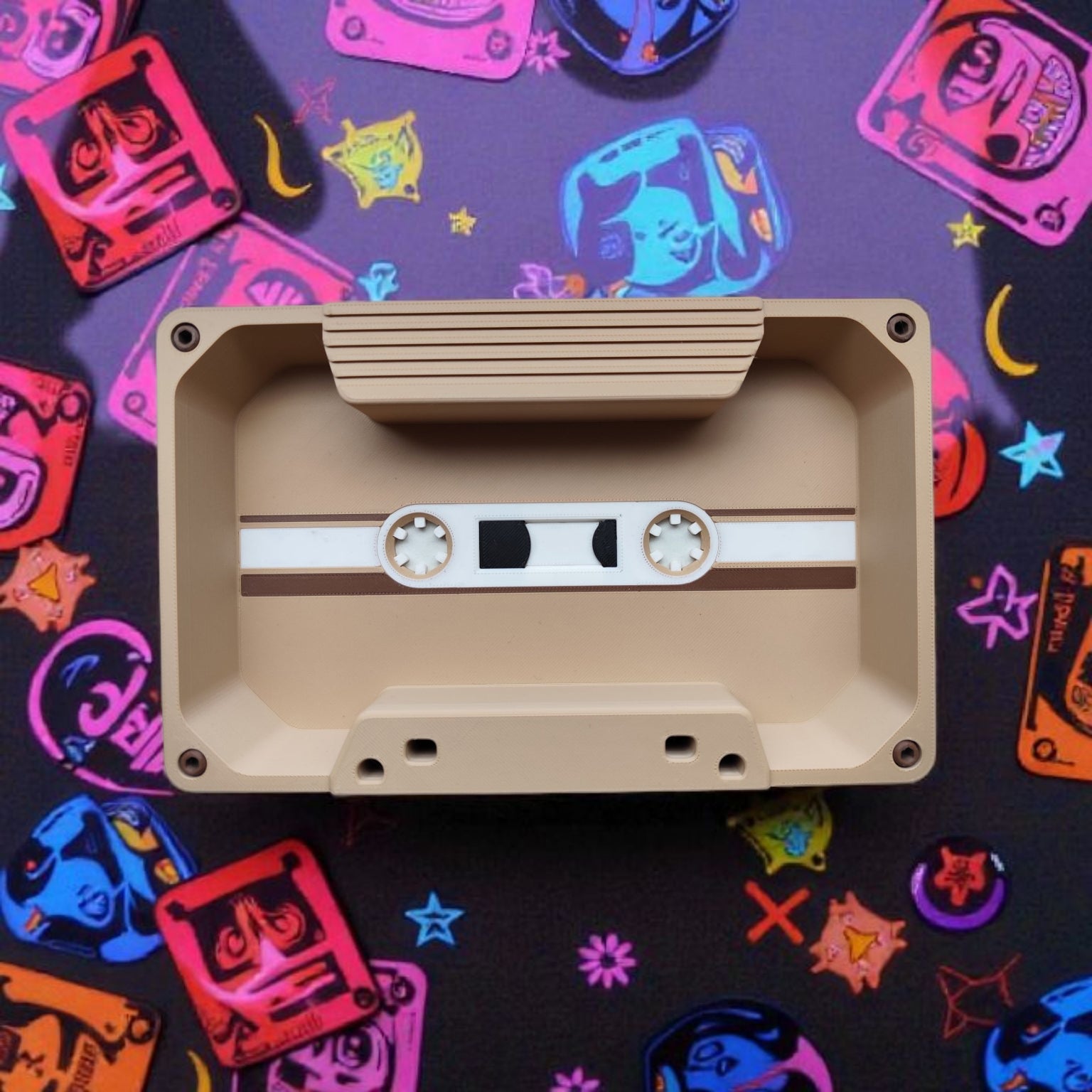 Beige cassette tape on a colorful background with retro design elements