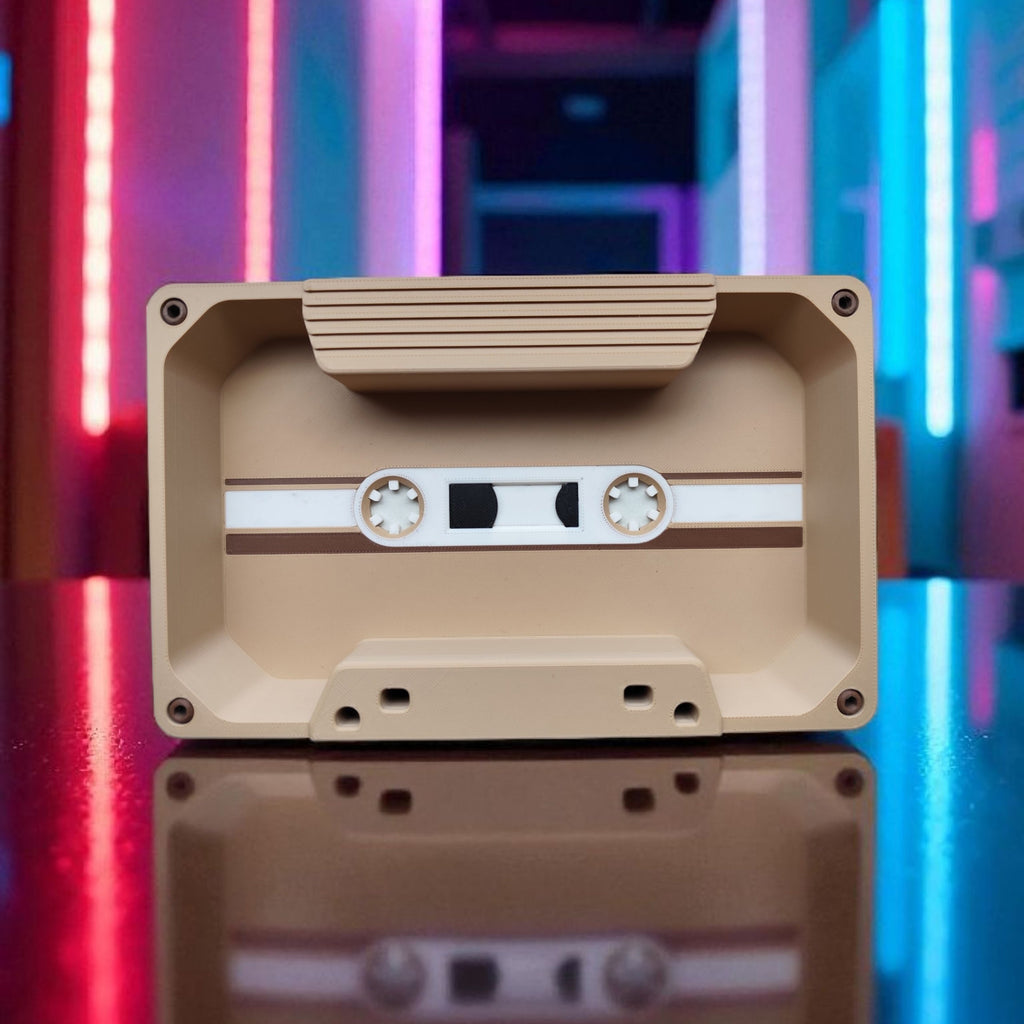 Beige cassette tape with a reflective surface against a colorful, abstract background