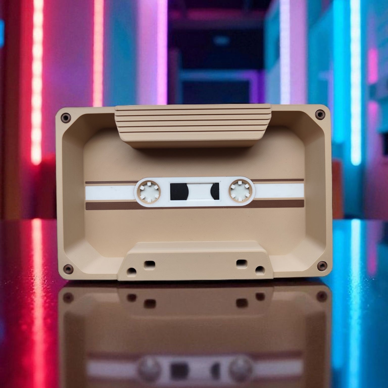 Beige cassette tape with a reflective surface against a colorful, abstract background