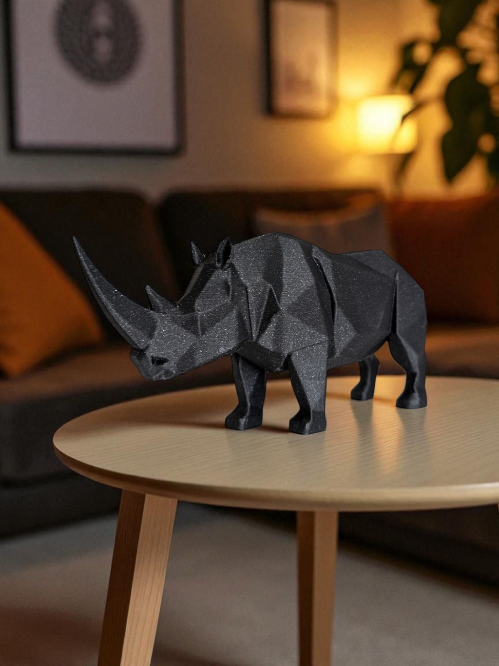 Geometric rhinoceros model on a wooden table in a cozy living room.