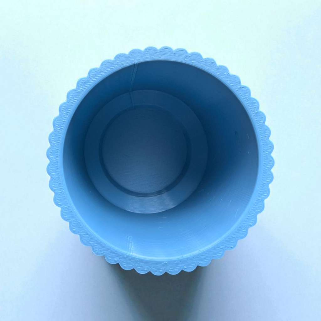 Close-up shot of the ribbed texture and tapered shape of a toothbrush cup.