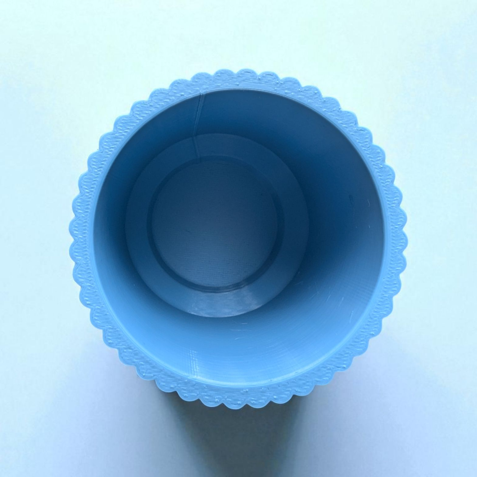 Close-up shot of the ribbed texture and tapered shape of a toothbrush cup.