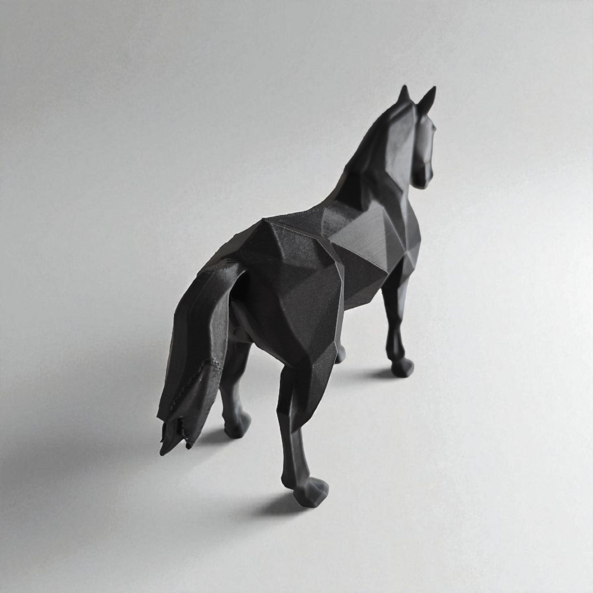Geometric horse sculpture on a plain background