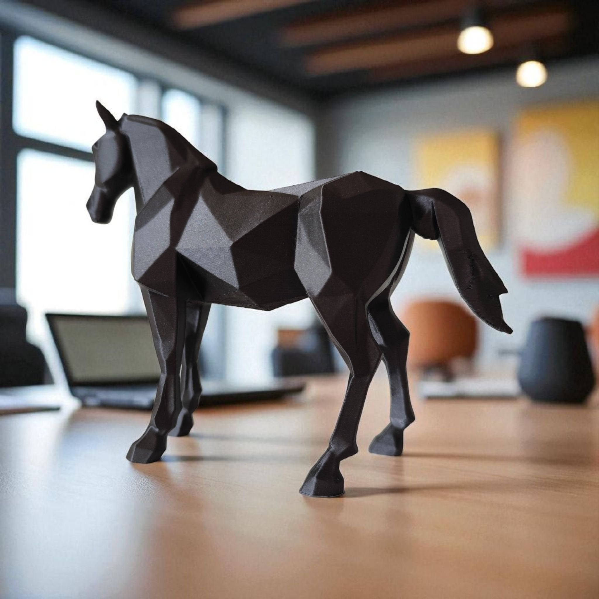 Geometric horse sculpture on a wooden floor with a blurred indoor background