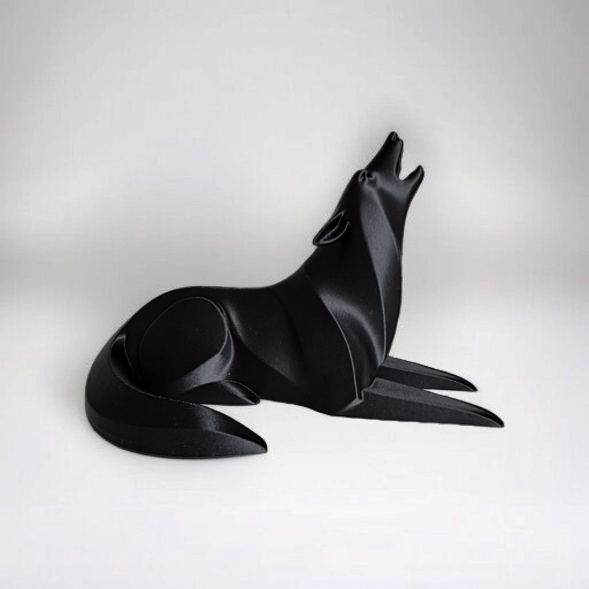 Black wolf-shaped object on a white background