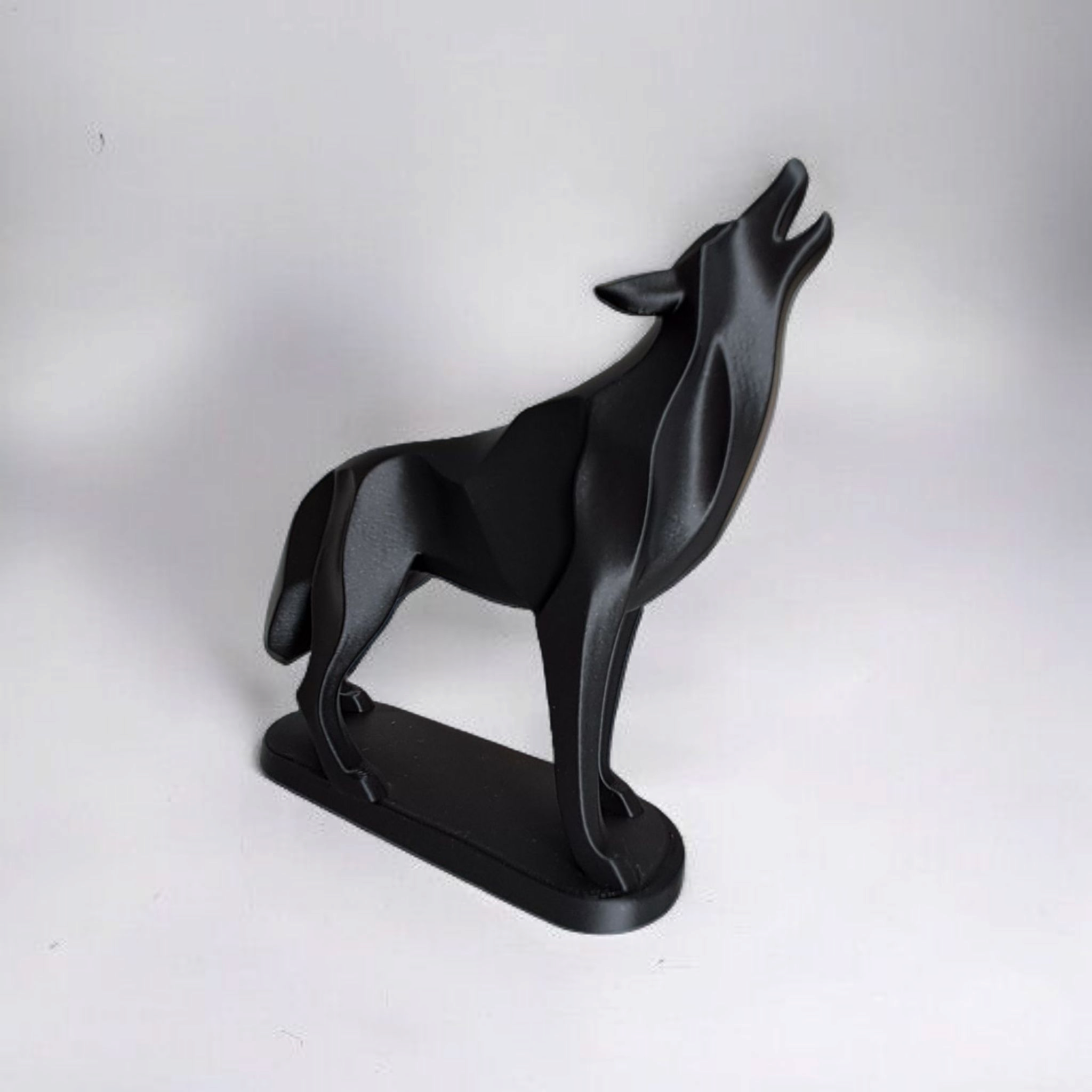 Black wolf-shaped object on a white background