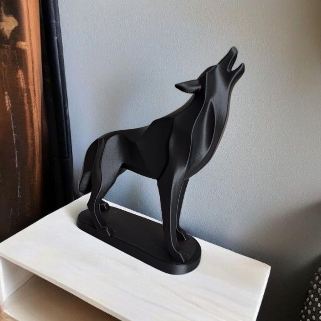 Black wolf sculpture on a white surface with a neutral background