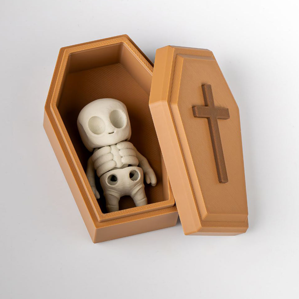 Skeletal figure in a wooden coffin with a cross on a white background