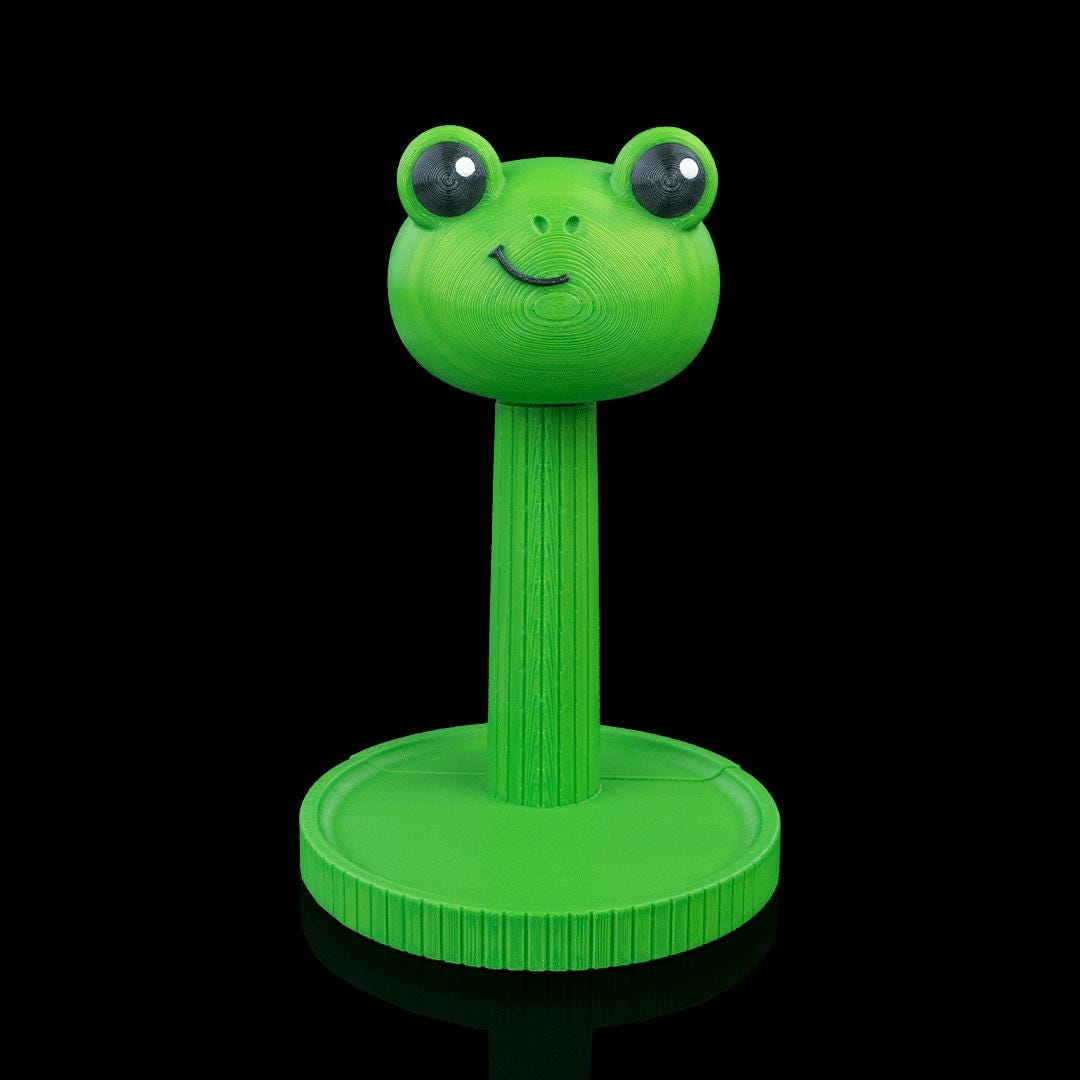 Empty green frog headphone stand from the front