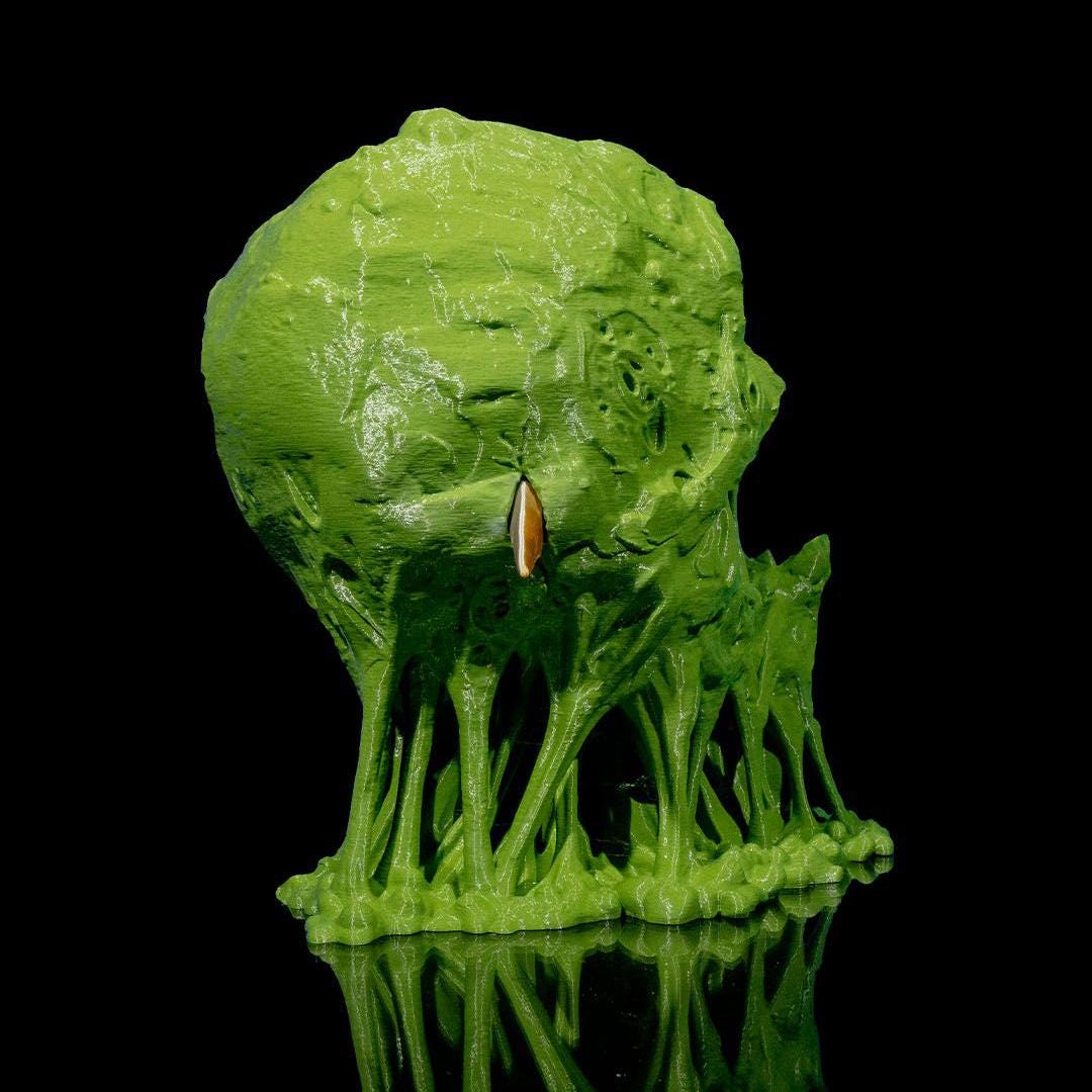 Green decorative rock with plants on a black background
