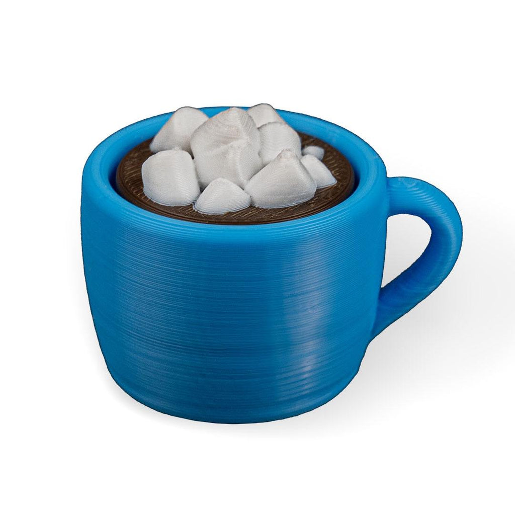 Blue mug filled with hot chocolate and marshmallows on a white background