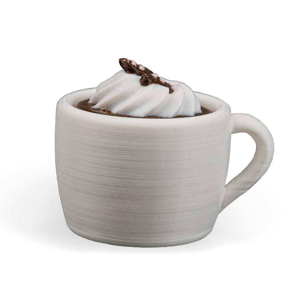 White ceramic mug with hot chocolate and whipped cream on a white background