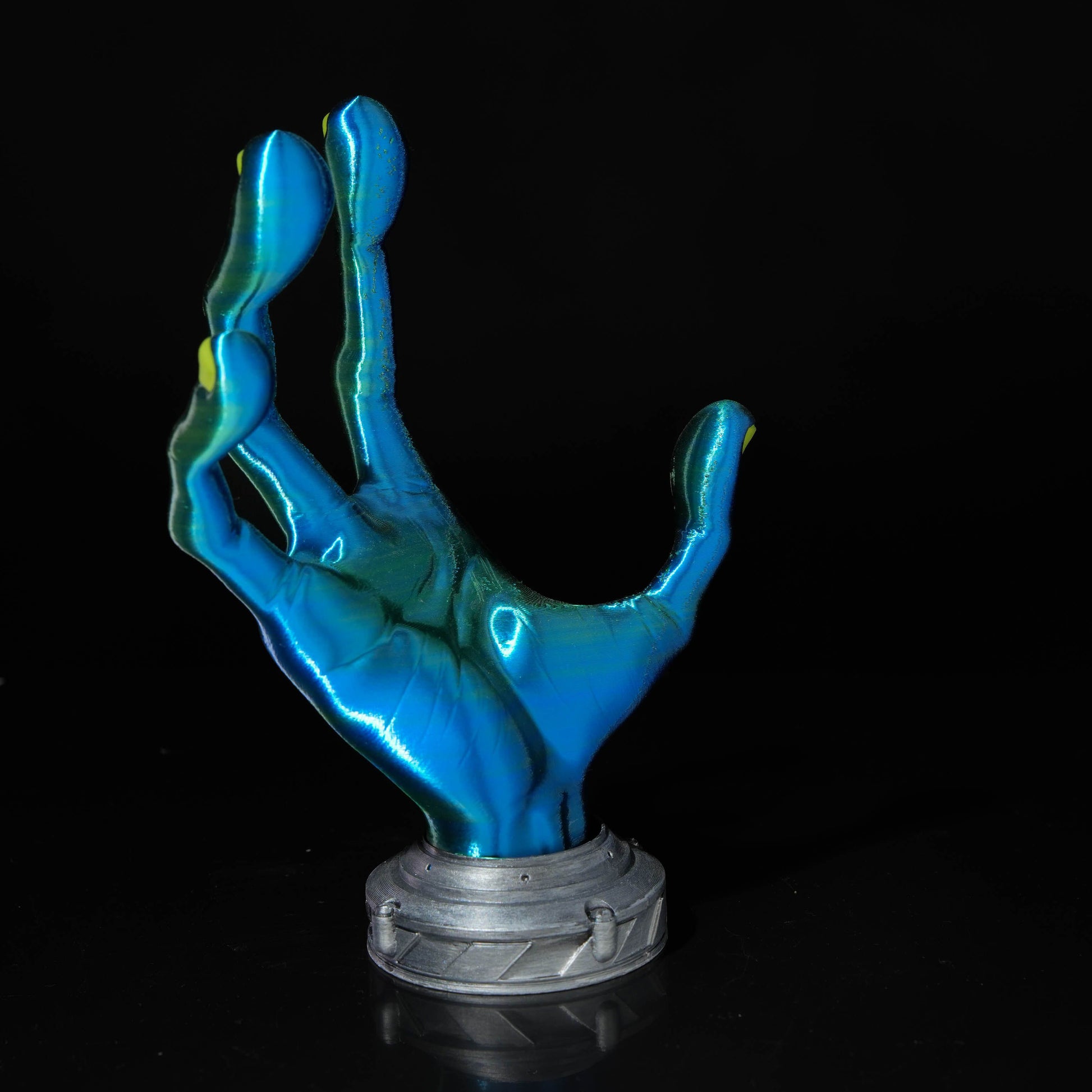 The Alien Hand Controller Holder functioning as a display for a gaming controller in a modern gaming setup.