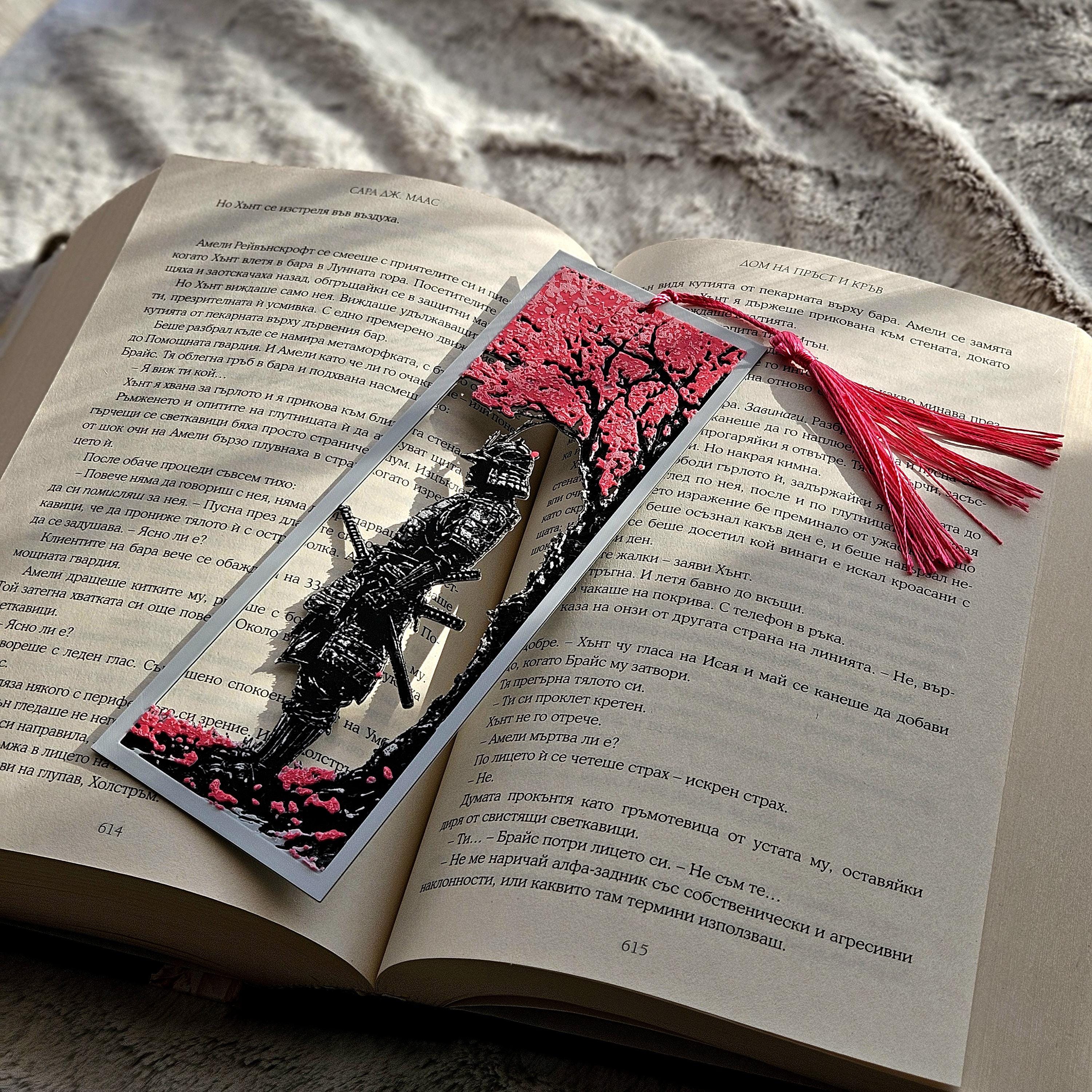 Decorative bookmark with a black ant design on an open book