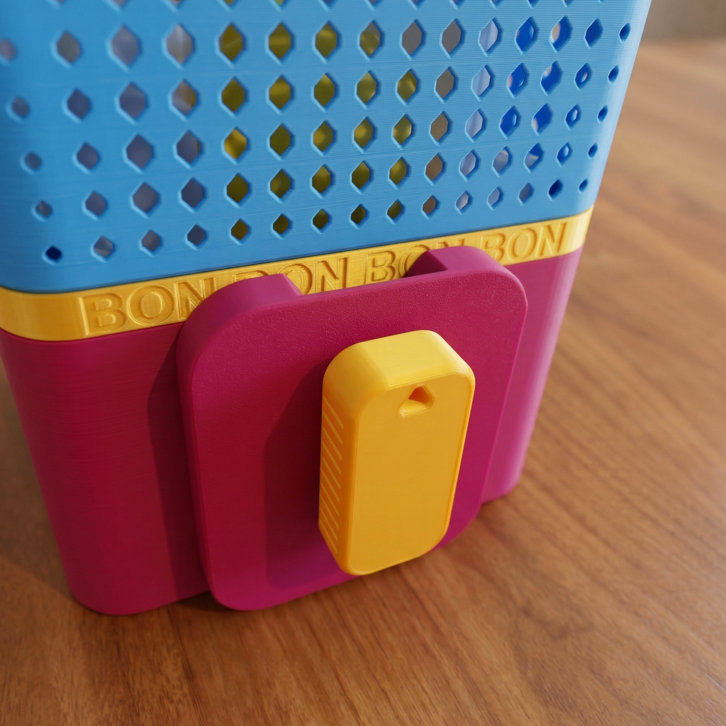 Colorful plastic toy with 'BON BON' branding on a wooden surface