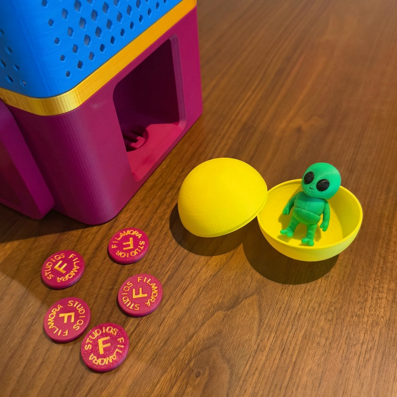 Toy figure in a yellow capsule with pink tokens on a wooden surface