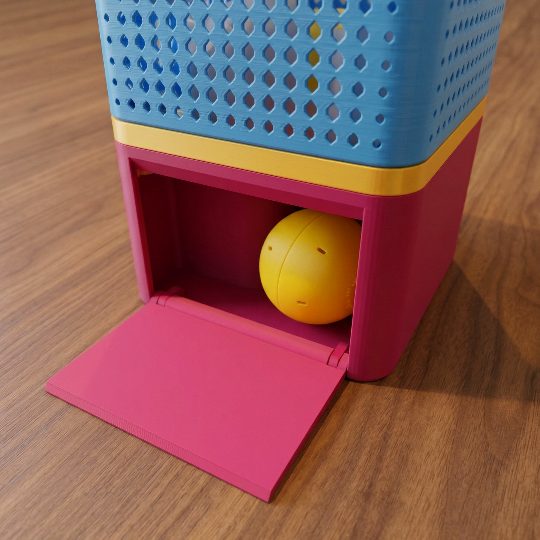 Colorful BONBON Vending Machine cube with a yellow ball inside on a wooden floor