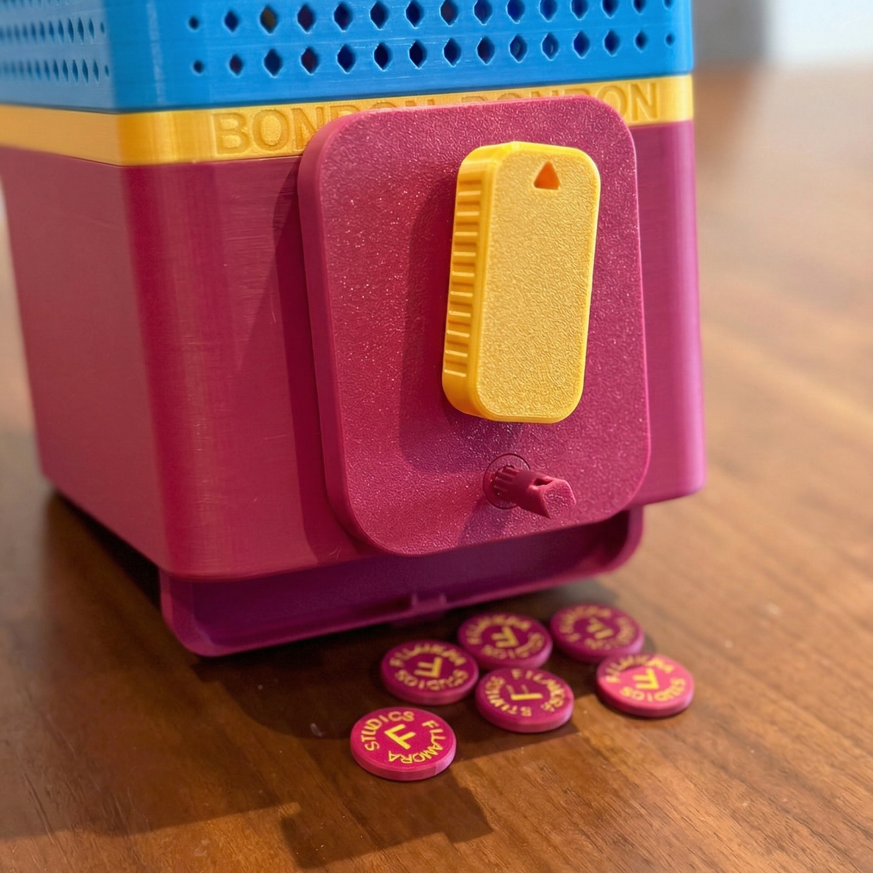 Colorful BONBON Vending Machine dispenser with pink buttons on a wooden surface