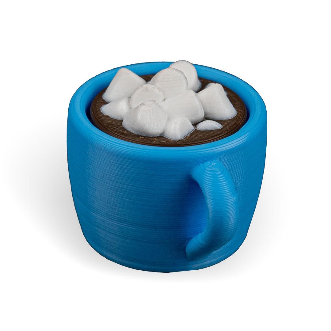 Blue mug with a chocolate drink and ice cubes on a white background