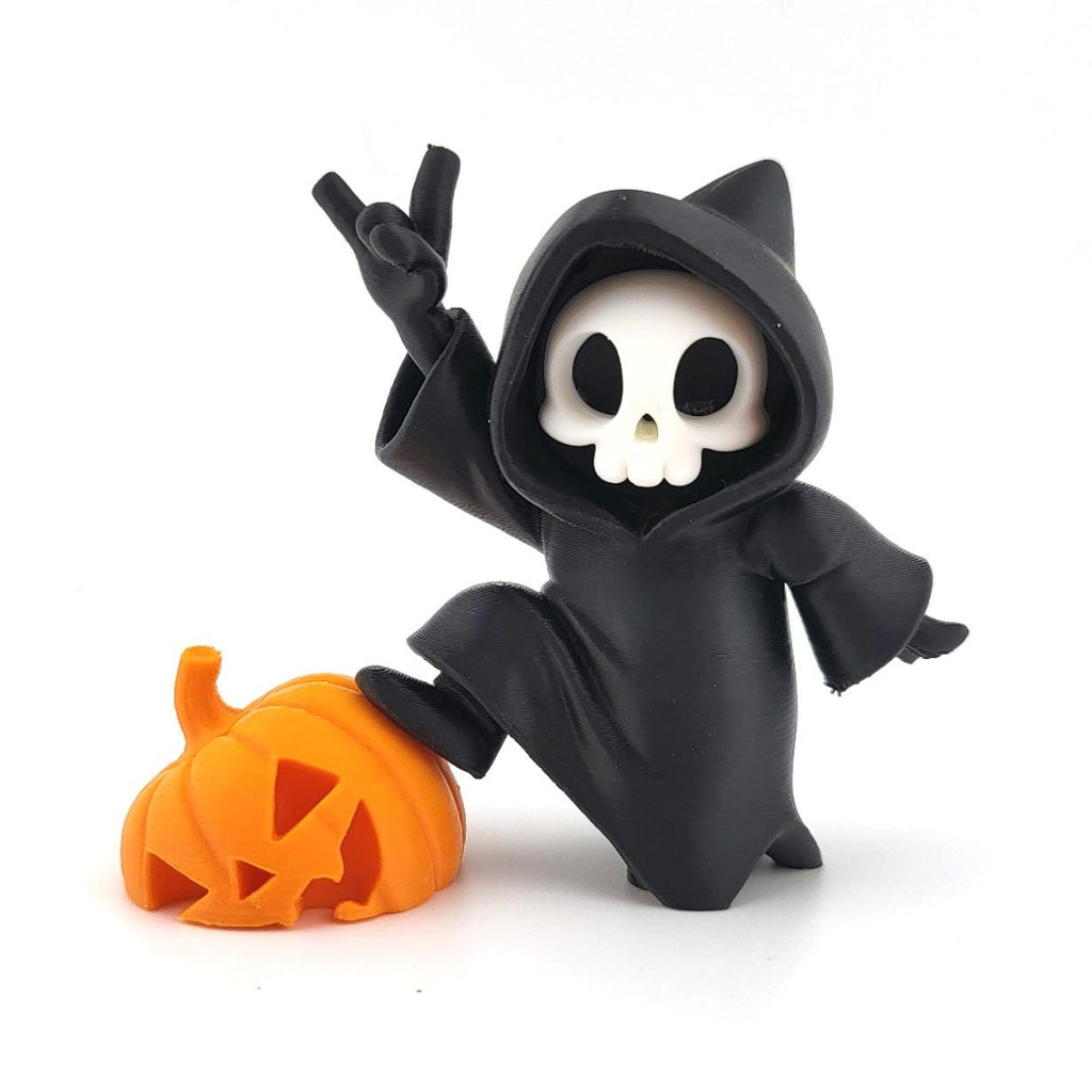 The Pumpkin Prankster grim reaper with a foot on a carved orange pumpkin, making a rock-on hand sign