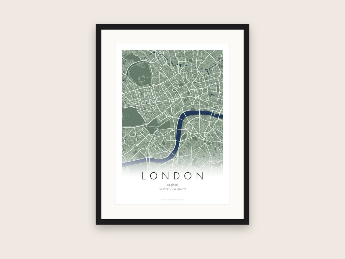 Personalised city map poster of London in a black frame: green streets and the blue Thames fading into the page above LONDON