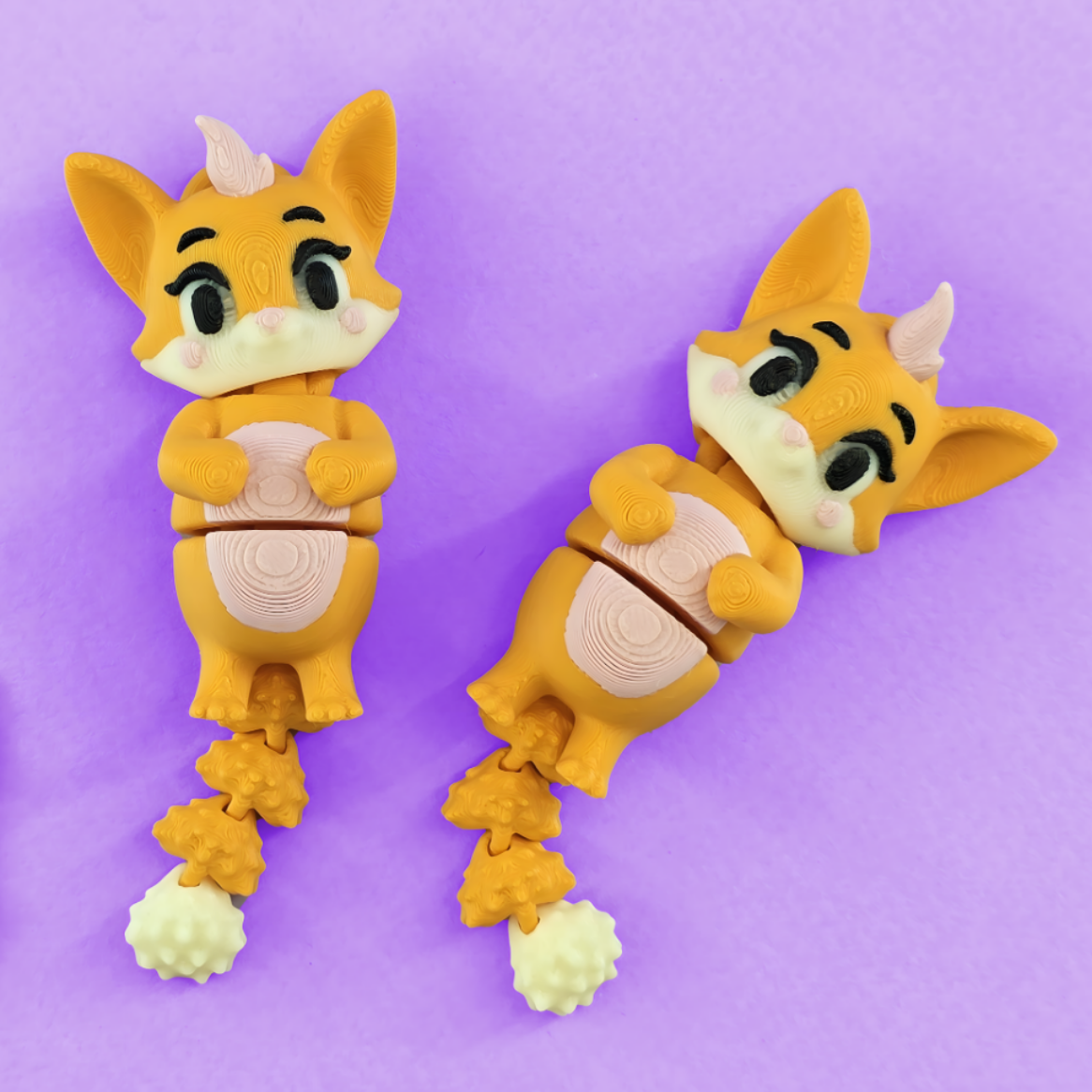 Two cartoon fox-shaped flexi toys on a purple background
