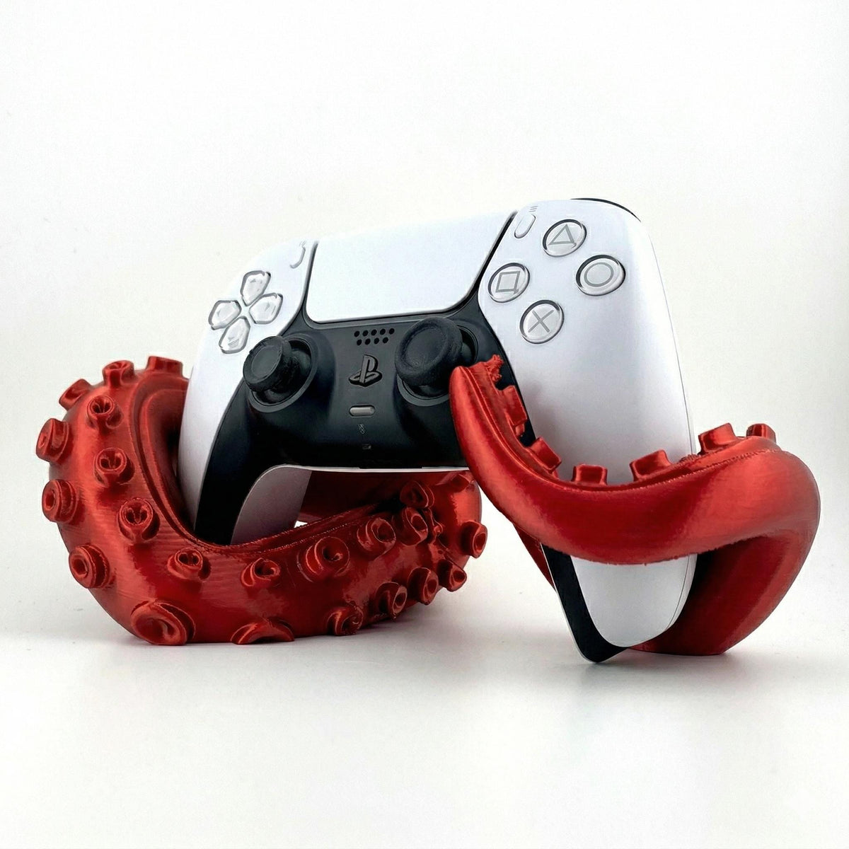 Red kraken tentacle stand with a PS5 controller