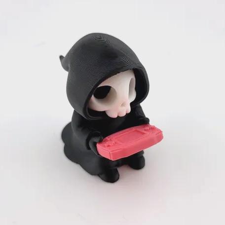 The Gamer grim reaper playing a red handheld console