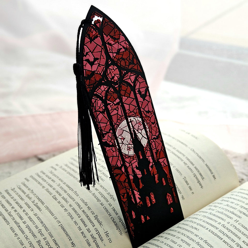 Gothic stained glass bookmark with a black tassel in an open book