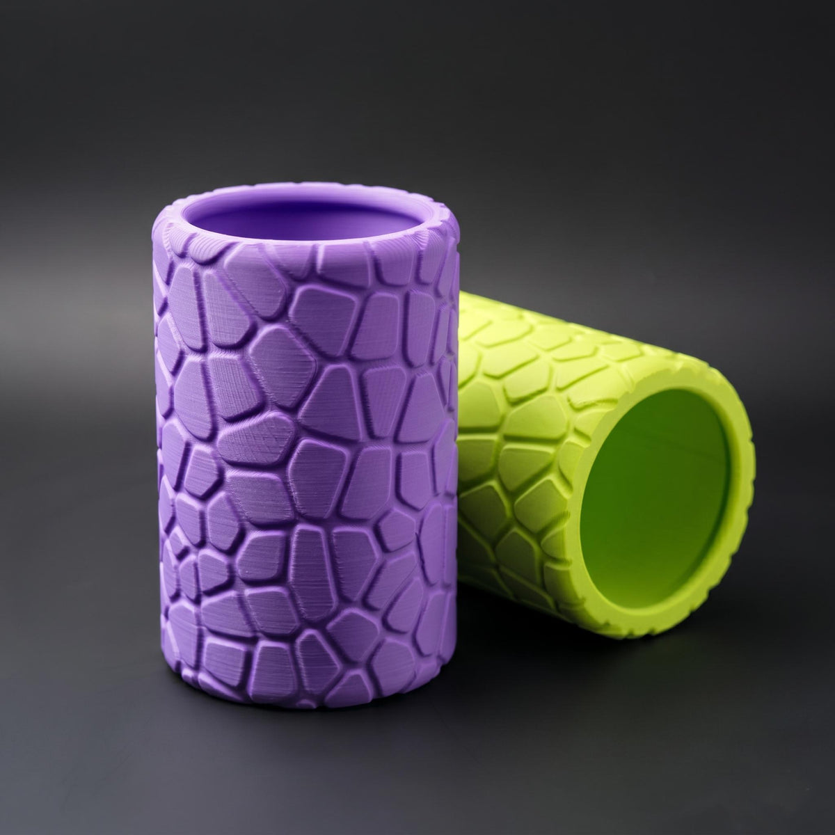 Purple pot standing in front of the lime pot lying on its side