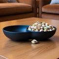 Blue divided bowl with pistachios on a wooden table
