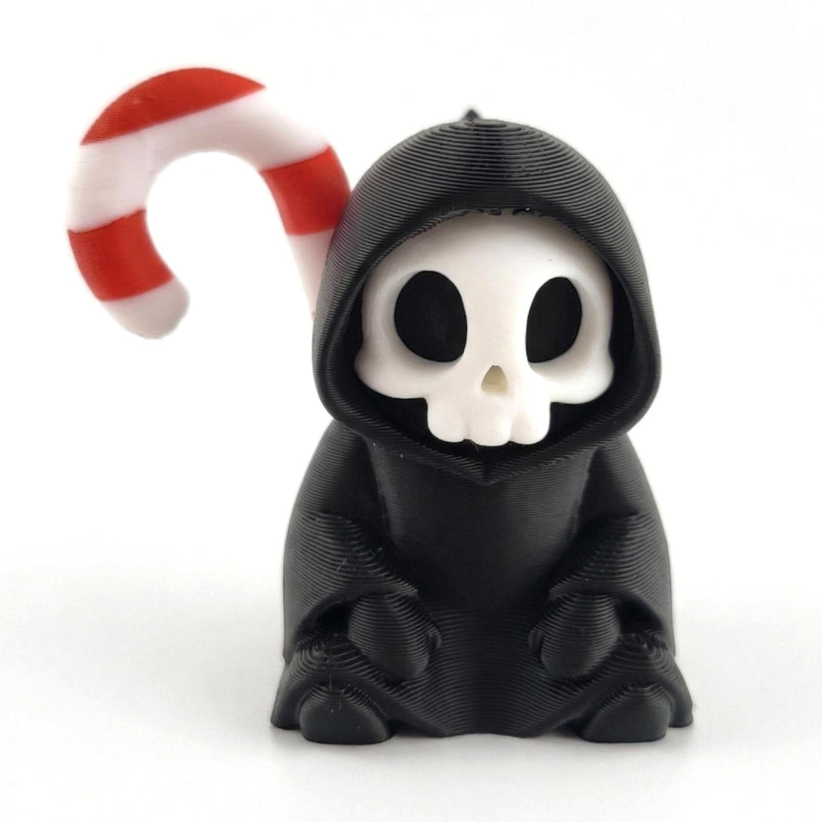 Candy Cane on the Back: a sitting grim reaper with a candy cane over its shoulder